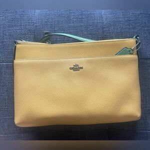 Coach bag yellow with green accent strap